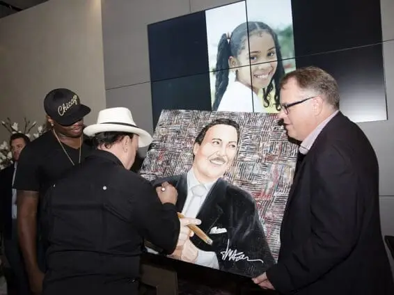 3.Carlito Fuente signing a painting by former Oklahoma City Thunder basketball player, Desmond Mason (now a professional artist)